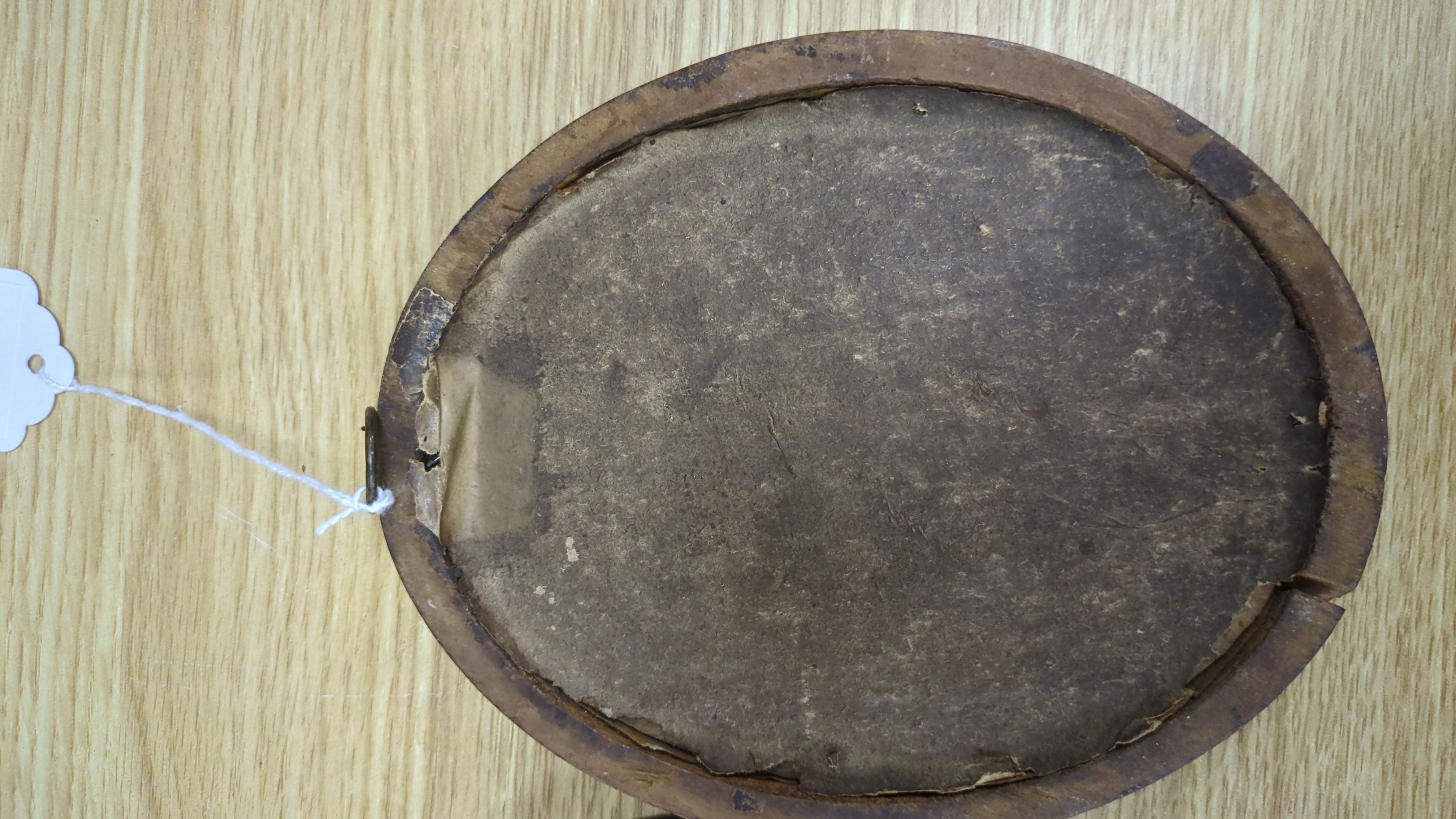 Three late Georgian silhouette portraits, verre eglomise mounts, largest 17cm high